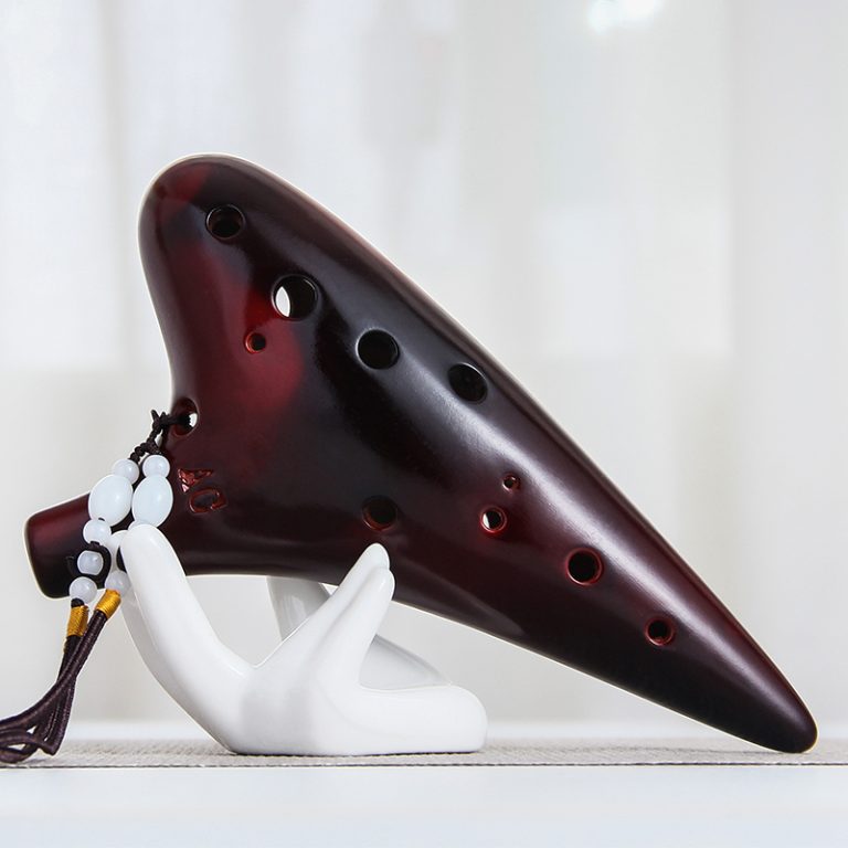Wooden, ceramic, and plastic ocarinas displayed side by side